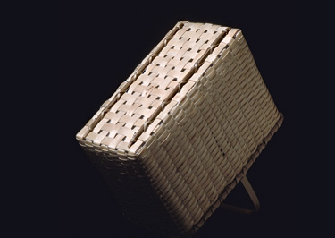 Open Carrier bottom view - a narrow rectangular basket with overhead handle showing hand carved runners to protect the bottom. Hand woven of brown (black) ash. Hand crafted by Stephen Zeh, Maine basketmaker