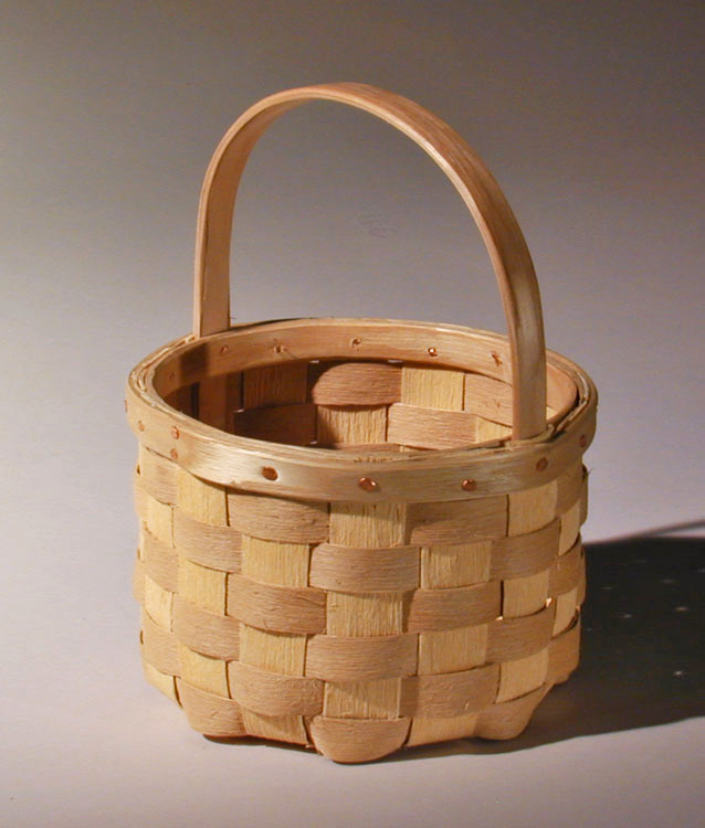 Berry Basket - round berry gathering basket with natural textured ash splint. The wide rim is fastened with a row of cut copper clench nails. Hand crafted of brown ash by Maine basket maker Stephen Zeh.