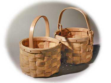 Bery Basket and Swing Handle Berry Basket - round bottom to round top baskets. The brown ash splint has the natural texture. The rims are hand split and carved with cut copper clench nails. These baskets are hand woven of brown ash (black ash) by Stephen Zeh, Maine basket maker.