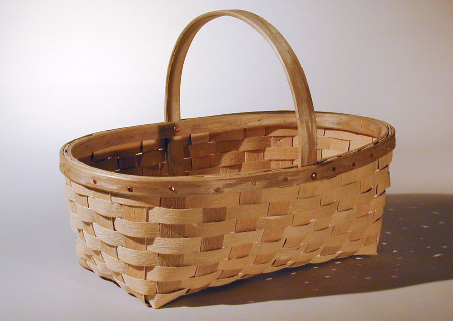 Garden Basket - oval garden and market basket with natural textured ash splint. The wide rim is fastened with a row of cut copper clench nails. Hand crafted of brown ash by Maine basket maker Stephen Zeh.