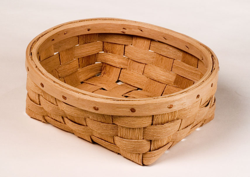 Oval bread basket with natural textured ash splint. The wide rim is fastened with a row of cut copper clench nails. Hand crafted of brown ash by Maine basket maker Stephen Zeh.