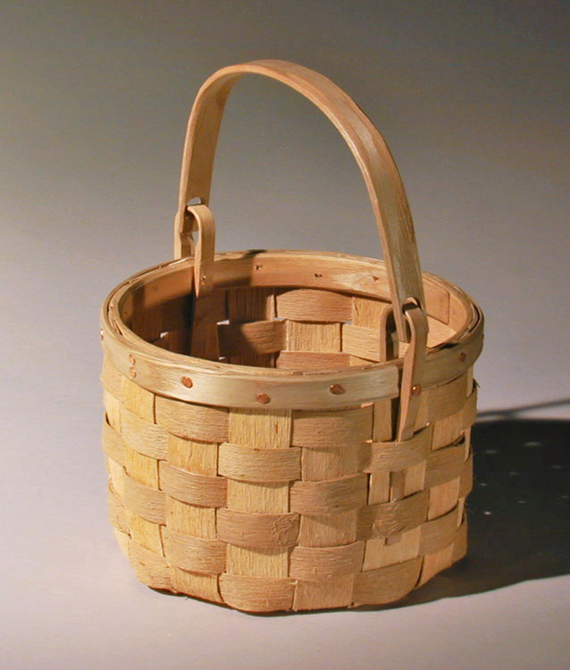 Swing Handle Berry Basket - round swing handled berry gathering basket with natural textured ash splint. The wide rim is fastened with a row of cut copper clench nails. Hand crafted of brown ash by Maine basket maker Stephen Zeh.