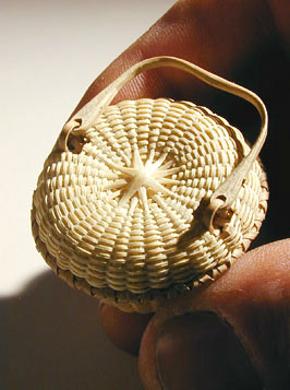 Miniature Covered Swing Handle Basket top view showing beveled sunburst pattern and bent loop swing handle