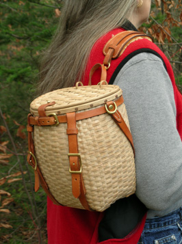 Maine Packbasket Purse worn over the shoulder - brown ash, brass, leather - by Stephen Zeh