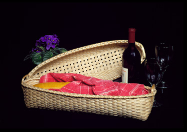 French Bread Basket with French bread and bottle of wine. Hand crafted of brown or black ash by Stephen Zeh, Basketmaker   of Temple, Maine.