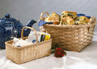 Bread Basket (right)and blueberry muffins on table with with Tea Basket, teapot, and rose - the Bread Basket is a square bottom to round top basket hand woven of brown ash (black ash) by Stephen Zeh, Maine basket maker.